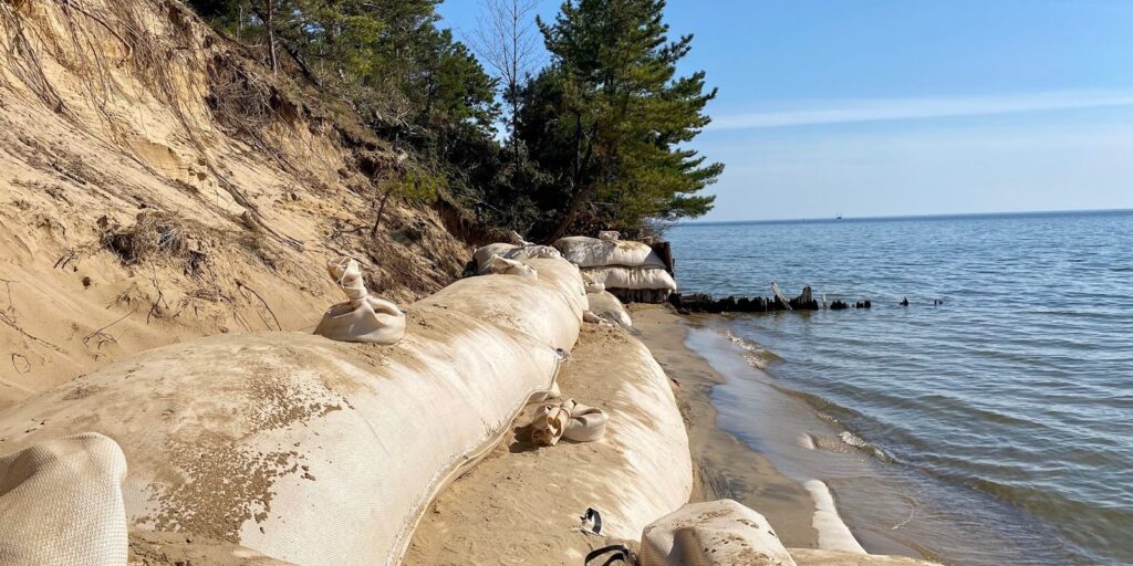 Geotubes on a lakeshore panorama